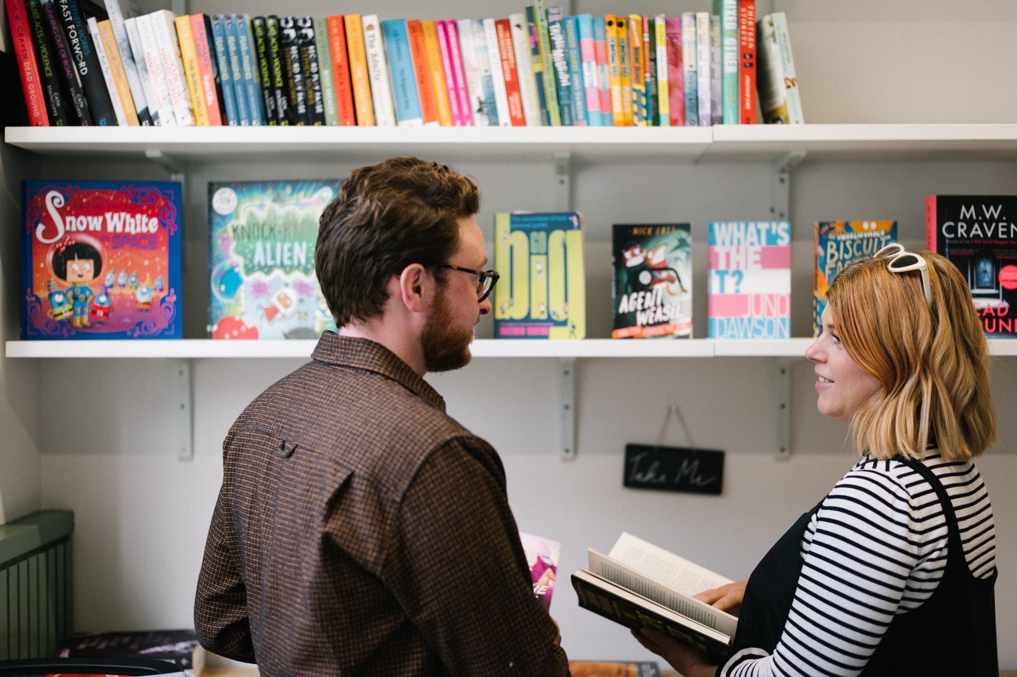 Colleagues at bookshelf